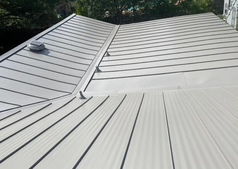 Solar attic fan installed on a metal roof for Roof Ventilation in Cahokia Heights
